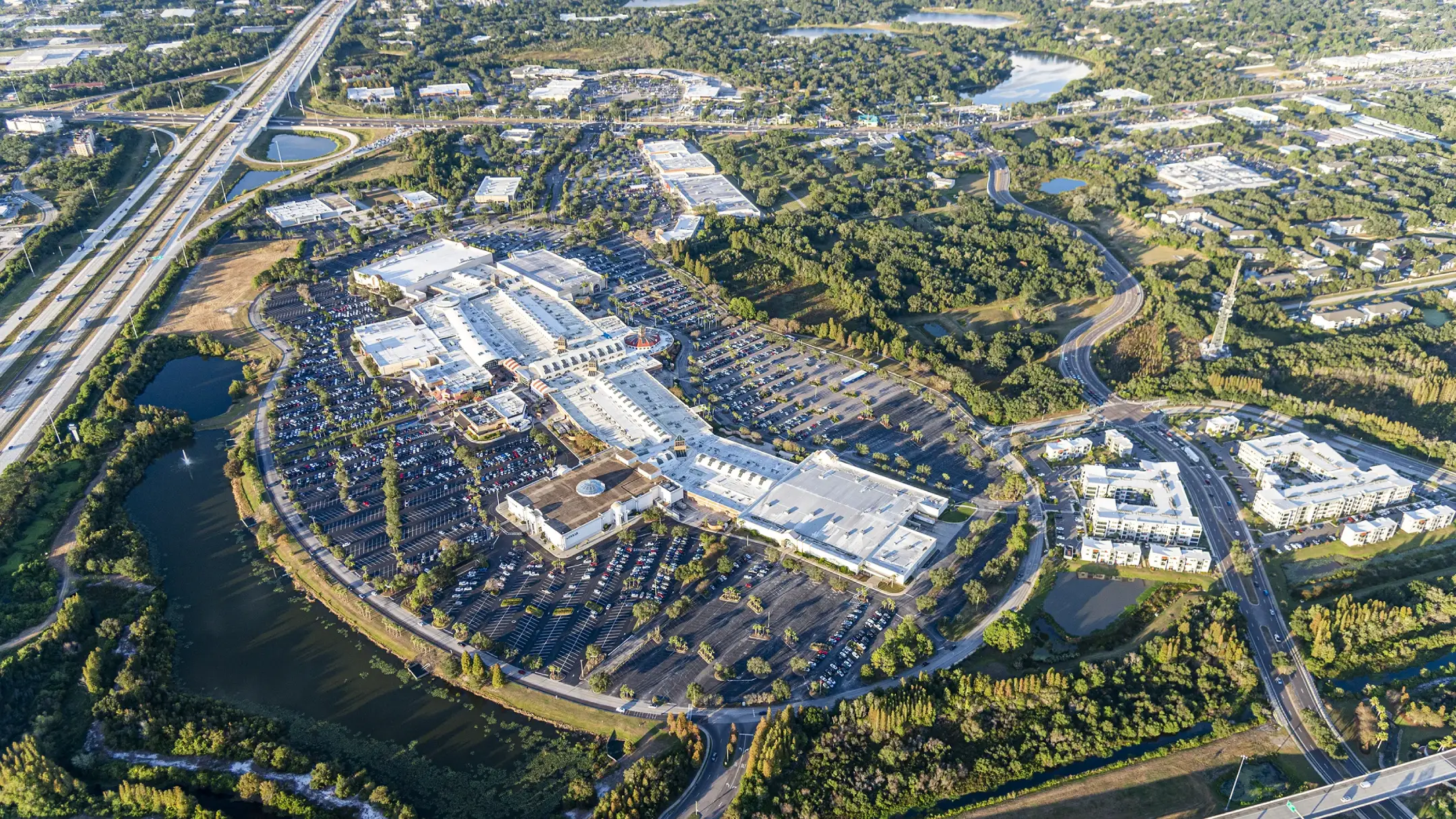 daytime aerial of brandon exchange shopping center showing the main building, parking and highway