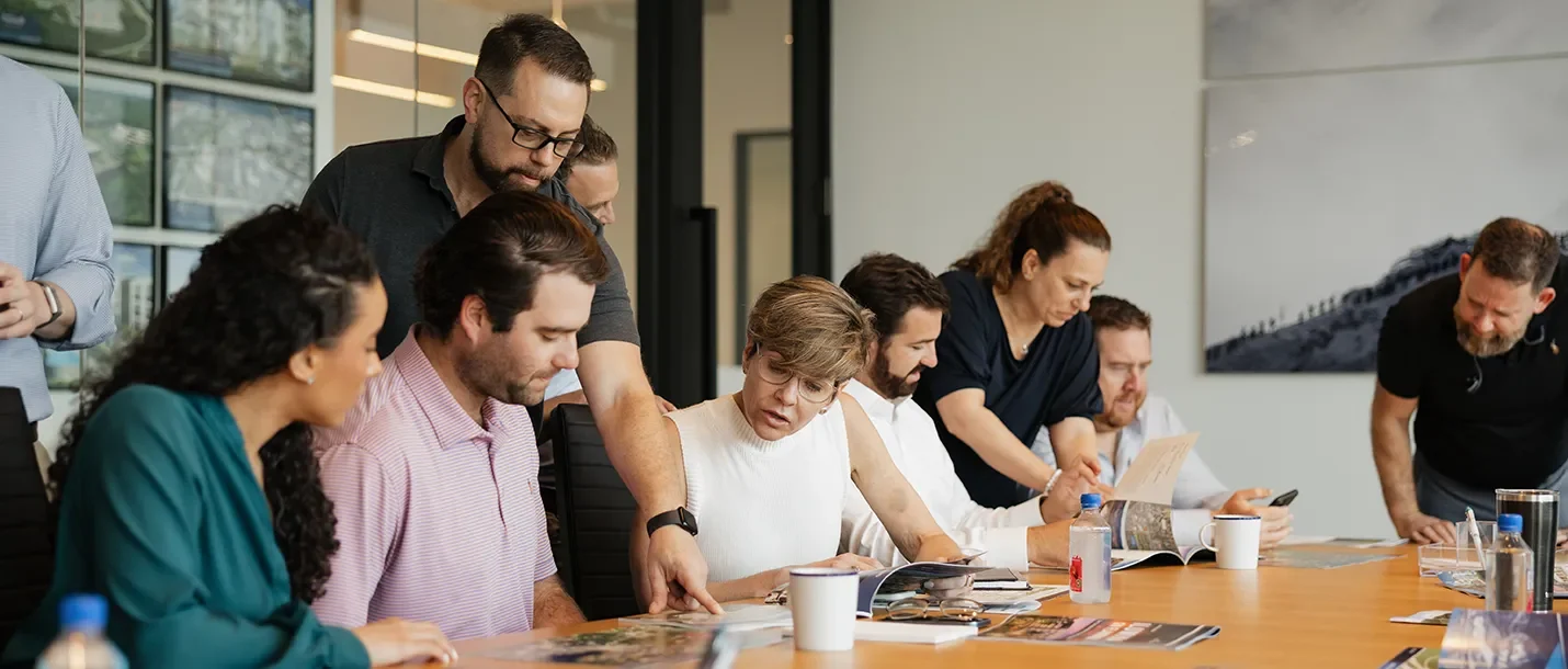 NADG team members in discussion in the boardroom
