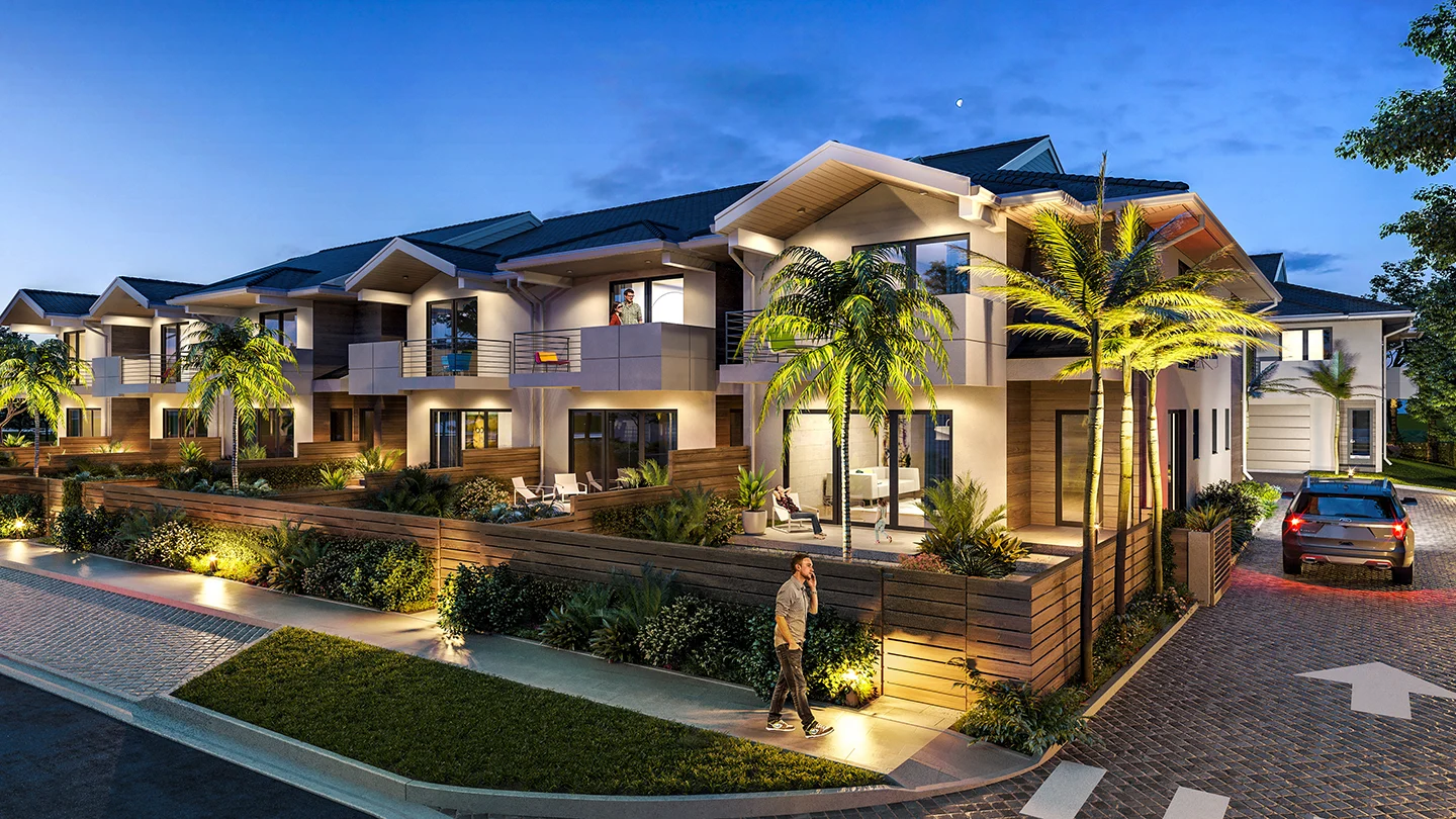 Evening rendering of a modern two-story townhome development at Nuvo Lighthouse Point. The buildings feature a mix of warm wood and neutral-toned exteriors with balconies, large windows, and well-lit patios. A pedestrian walks along a landscaped sidewalk illuminated by ground lighting. A car with headlights on is turning into the driveway under a dusky blue sky with a visible crescent moon. Palm trees and decorative plants line the fenced front yards, creating a tropical ambiance.
