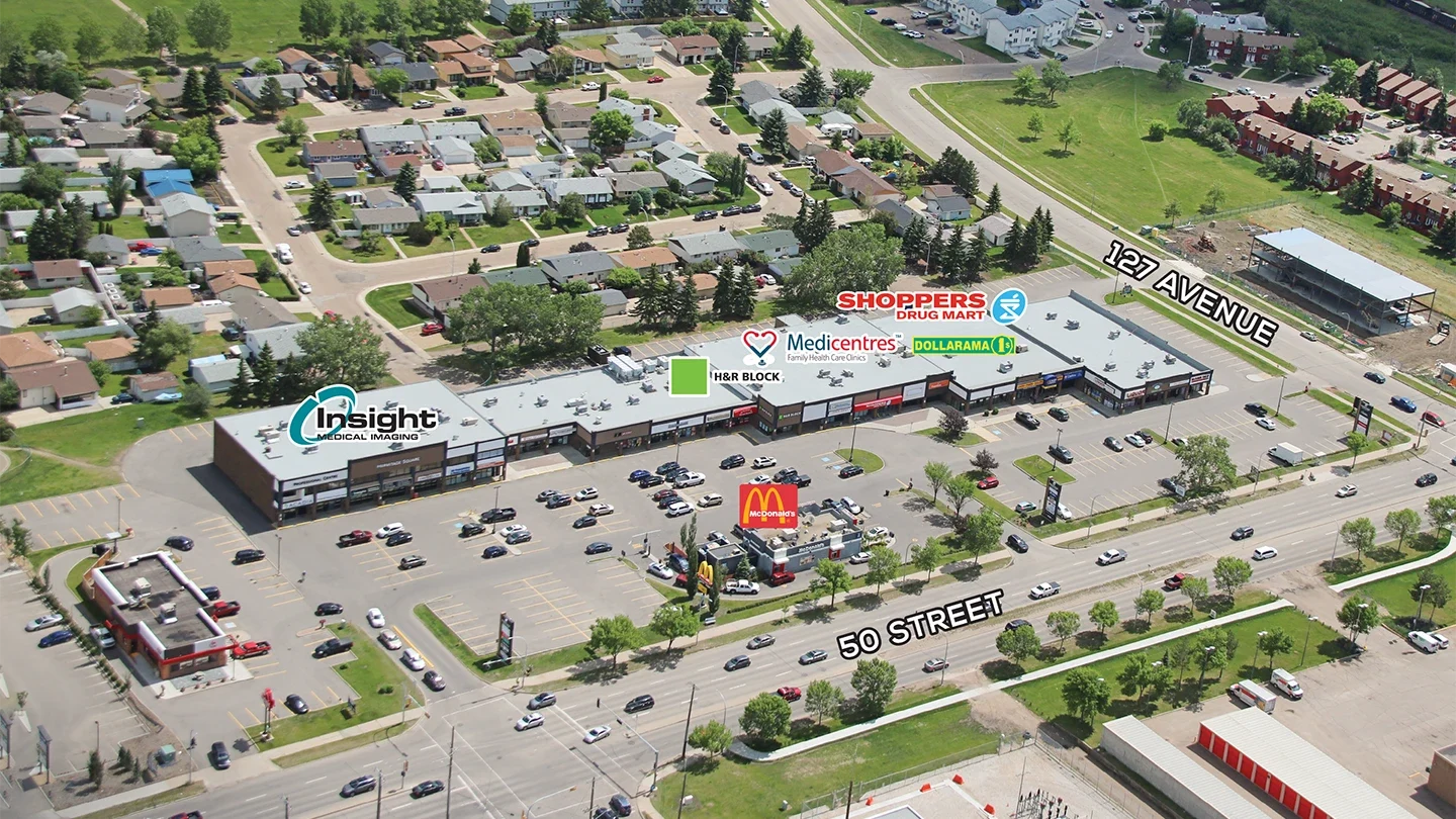 Labeled aerial view of Hermitage Square at the intersection of 127 Avenue and 50 Street. Visible tenants include Shoppers Drug Mart, Dollarama, Medicentres, H&R Block, and Insight Medical Imaging. A McDonald