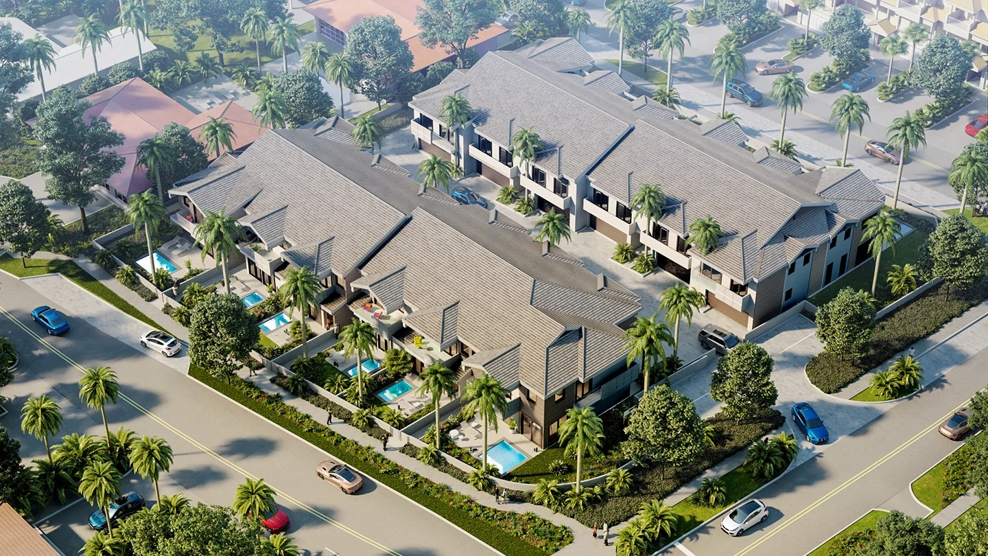 Aerial view of NUVO Lighthouse Point featuring multiple two-story townhome buildings with grey tile roofs, surrounded by palm trees and lush landscaping. Several units have private plunge pools and fenced-in patios facing the street. The development includes driveways, walkways, and a central parking area. The surrounding neighborhood features additional homes, roads with light traffic, and tropical vegetation under a sunny sky.
