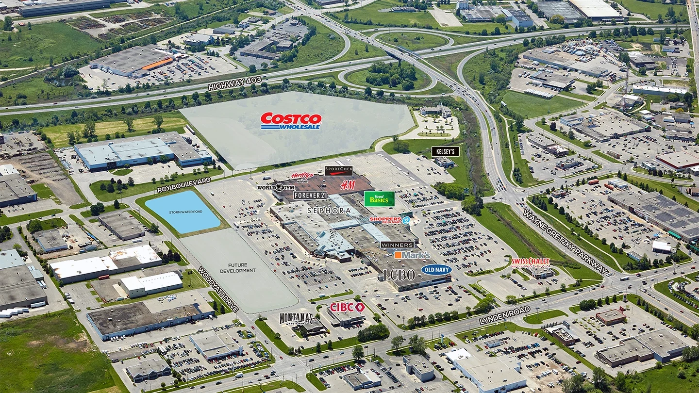 Aerial photograph of Lynden Park Mall showing labeled stores including Costco, Food Basics, Sephora, H&M, LCBO, Old Navy, and more. Roads such as Highway 403, Wayne Gretzky Parkway, and Lynden Road are visible, along with nearby commercial and industrial buildings.