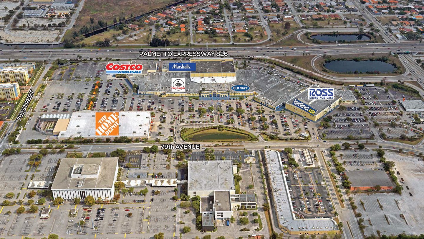 A labeled aerial photograph of the Midway Crossings retail center showing major store names such as The Home Depot, Costco, Marshalls, Foot Locker, Old Navy, Ross Dress for Less, and TigerDirect.com. The shopping complex is bordered by 79th Avenue, 72nd Street, and the Palmetto Expressway (826), with residential neighborhoods and a highway interchange in the surrounding area.